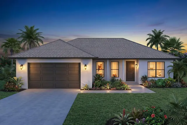 A single-story house with a dark garage door and palm trees at dusk