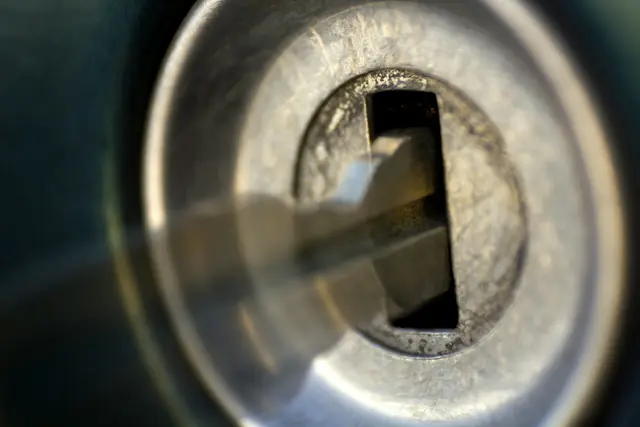 A key inserted into a lock cylinder, close up